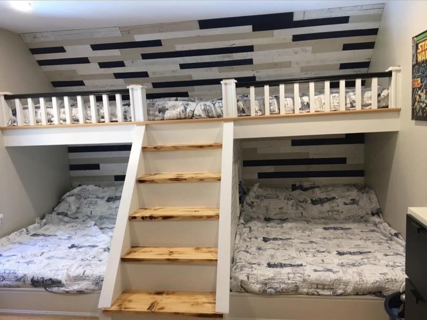 Two built-in beds under a railed loft bed, reached by a white staircase with pine treads